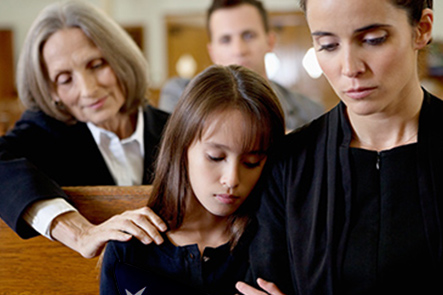 Mother and daughter at military funeral