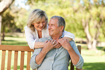 Image of hands with a picture of a happy elderly couple